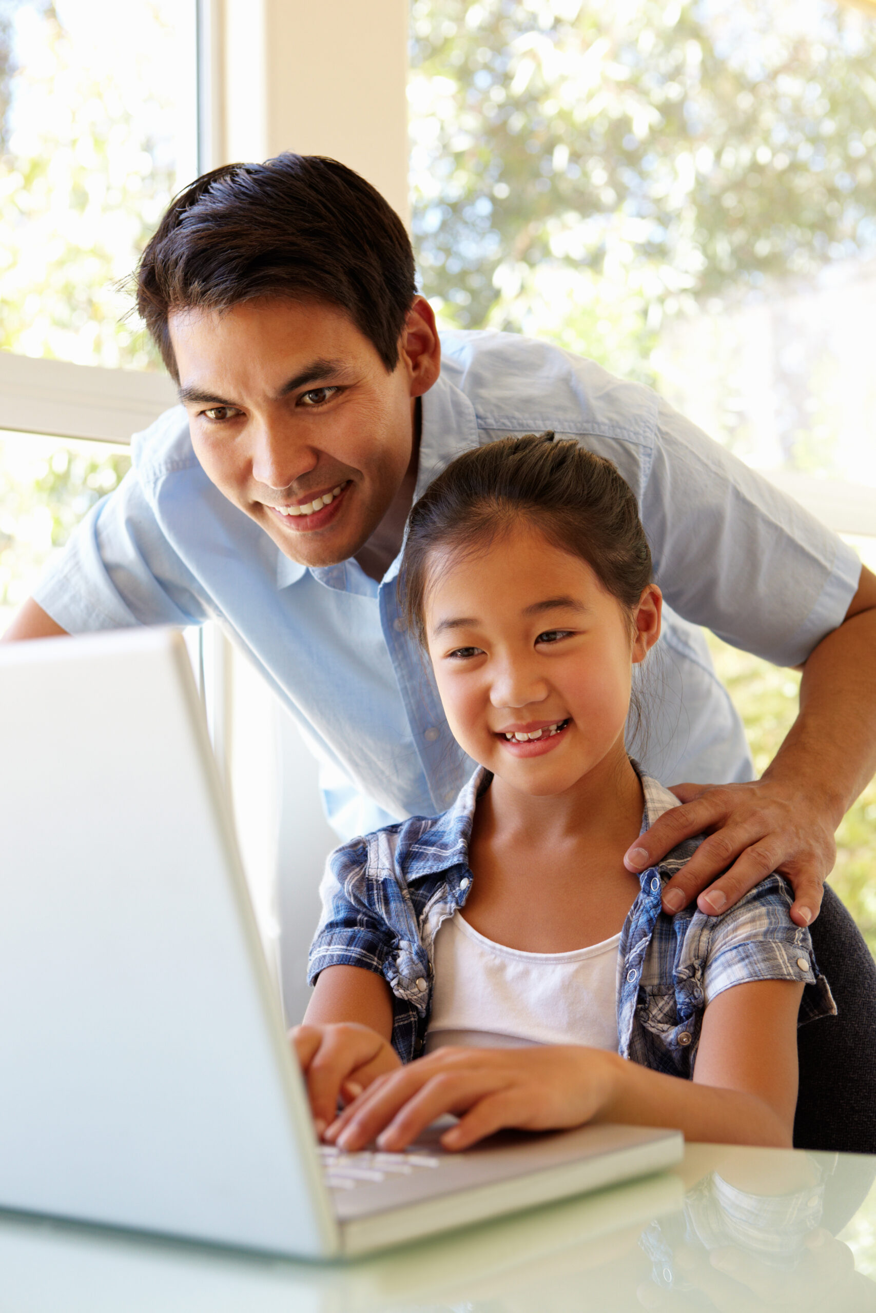 Father and daughter using laptop for online therapy in ny<br />
