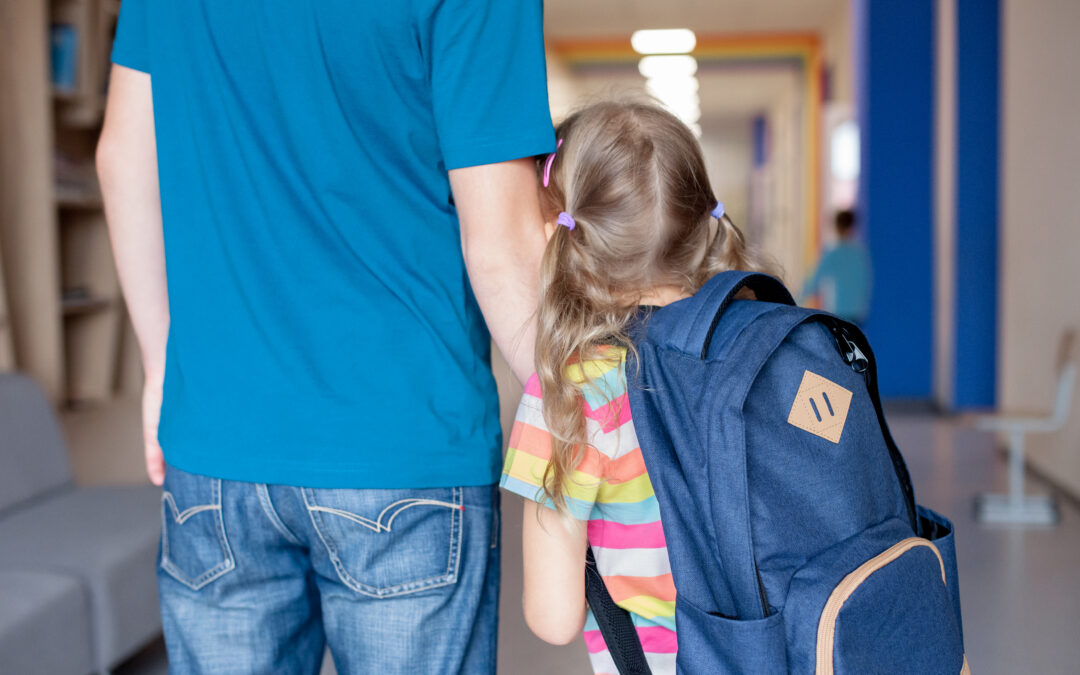 First Day At School. Stressed And Worried Kid And Father Holding Hands. Child Girl With Backpack In First Grade Of Primary School. Concept Of Back To School Crisis, Support, Protection, Togetherness